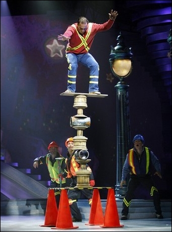 Circus actor balancing on cylinders